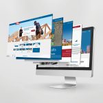 A computer monitor displays overlapping website pages, including construction, maps, and business statistics, against a plain light background.