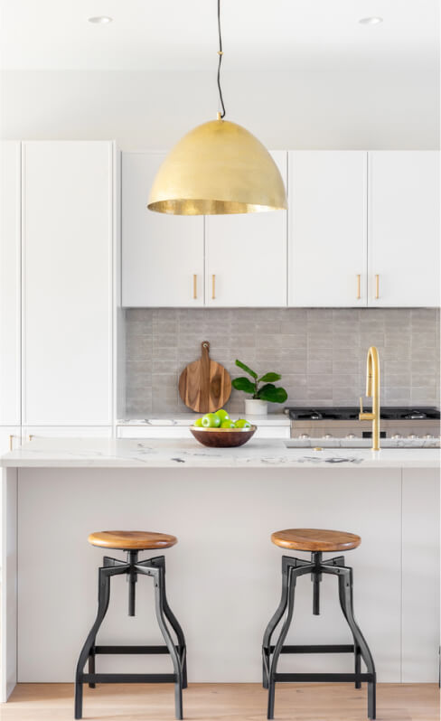 img - kitchen-detail-white-cabinets-gold-faucet-light-hanging-island-bar